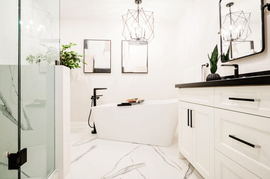 A spa-like bathroom renovation by Zzone Homes in Hamilton featuring a sleek vanity, modern fixtures, and a spacious walk-in shower.