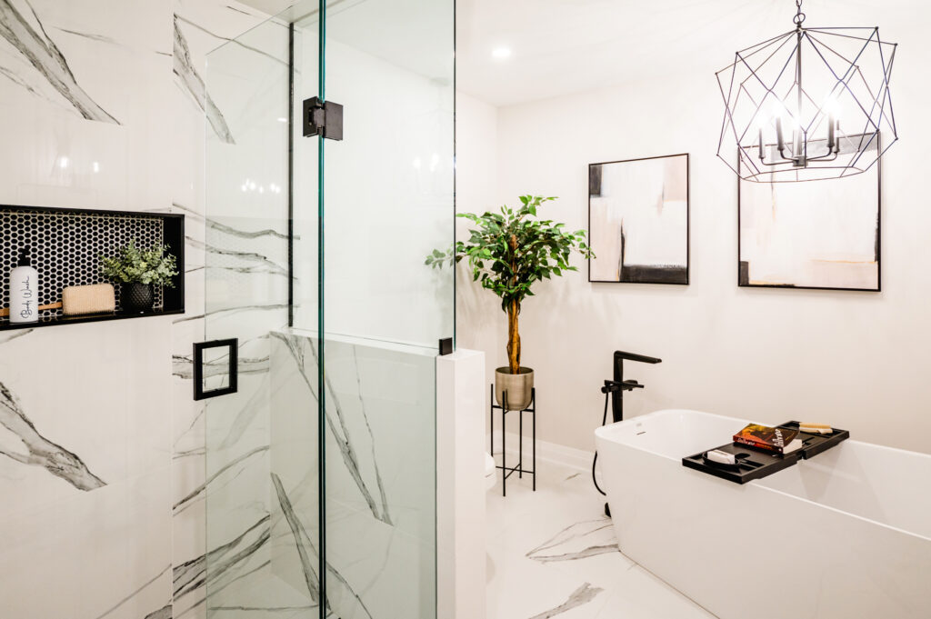 Luxury bathroom renovation in Hamilton by Zzone Homes featuring custom glass shower and marble tile.